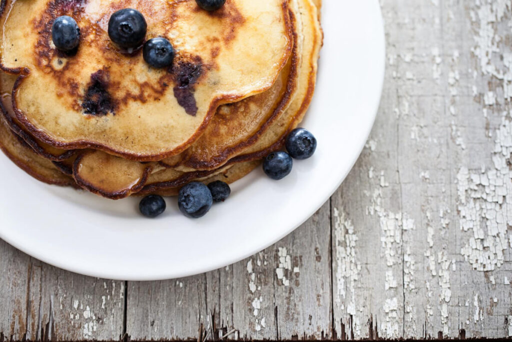 Croissant French toast topped with berries and powdered sugar.