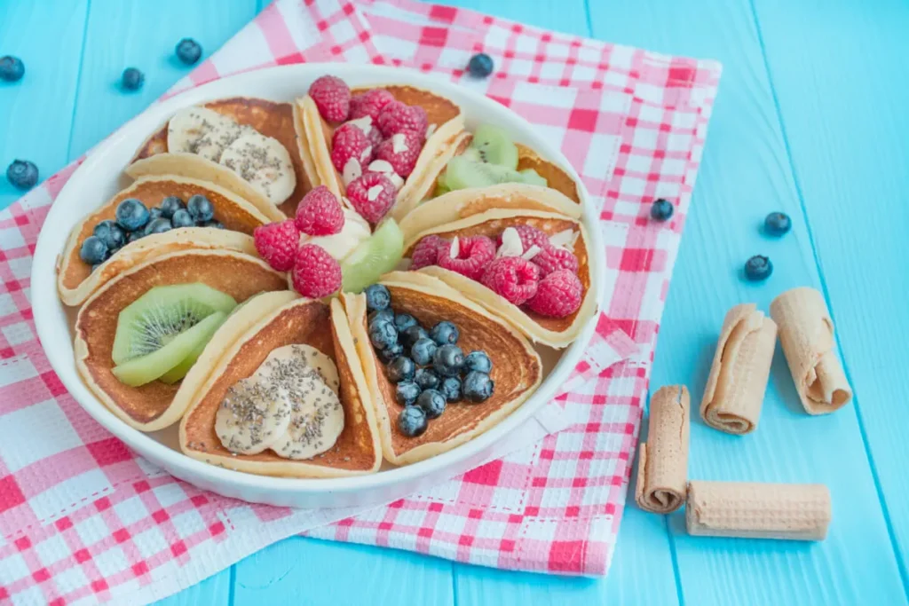 Healthy pancakes made with whole grains and topped with fresh berries and honey.