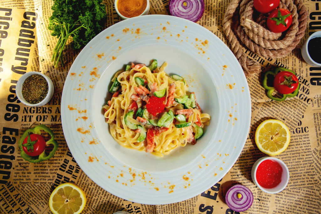 A serving of spaghetti casserole plated with a green salad and garlic bread, garnished with parsley.