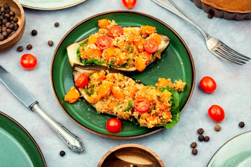 A plated serving of vegan eggplant parmesan with crispy breading and marinara sauce.